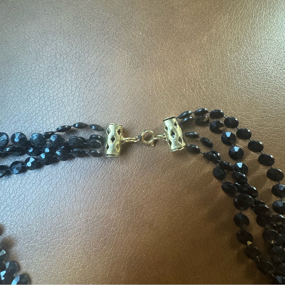 Four-strand black faceted bead necklace